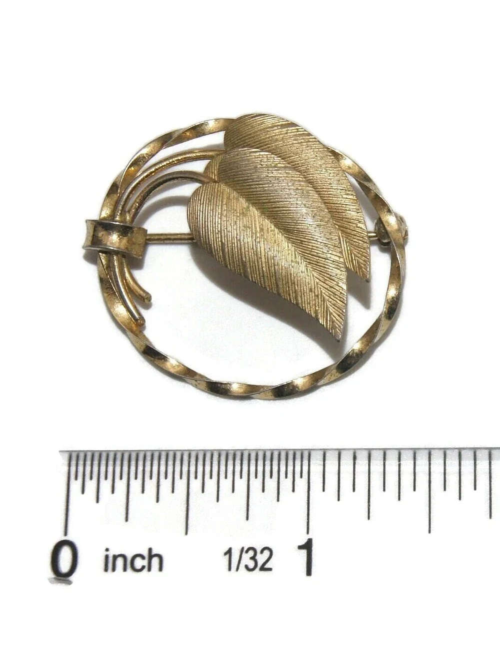 Vintage Gold Tone Brooch with Golden Leaves in a Twisted Oval Frame.